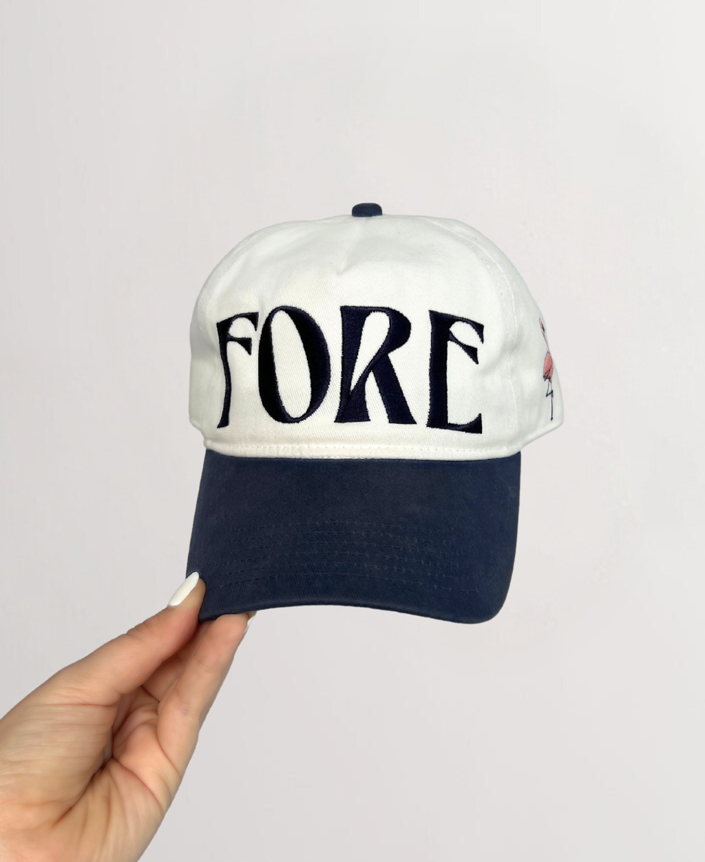 Front of ball cap with Indigo Stitching reading &quot;FORE&quot; on a white hat and Indigo hat brim