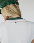 A women's golf polo named "Angie Polo" with capped sleeves and a retro preppy design. This fitted polo accentuates curves without being too tight, allowing for comfortable movement on the course. Perfect for a timeless, stylish look while playing golf