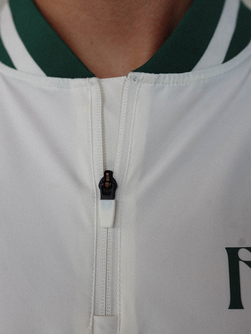 "Close-up of the 'Hamilton Quarter Zip' from the Royal Collection, inspired by autumn hues. This men's quarter zip features complementary color blocking and a convenient zip for easy wear. Made from breathable material, it offers warmth and freedom of movement, ideal for the course and elevating your fall wardrobe with both style and functionality."