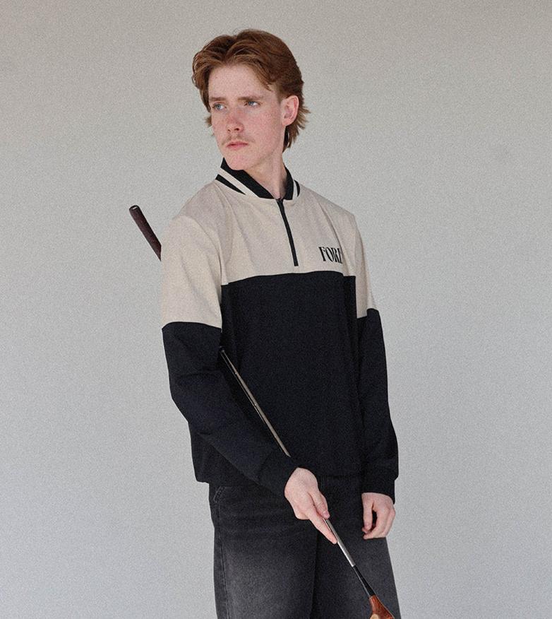 &quot;Close-up of the &#39;Hamilton Quarter Zip&#39; from the Royal Collection, inspired by autumn hues. This men&#39;s quarter zip features complementary color blocking and a convenient zip for easy wear. Made from breathable material, it offers warmth and freedom of movement, ideal for the course and elevating your fall wardrobe with both style and functionality.&quot;