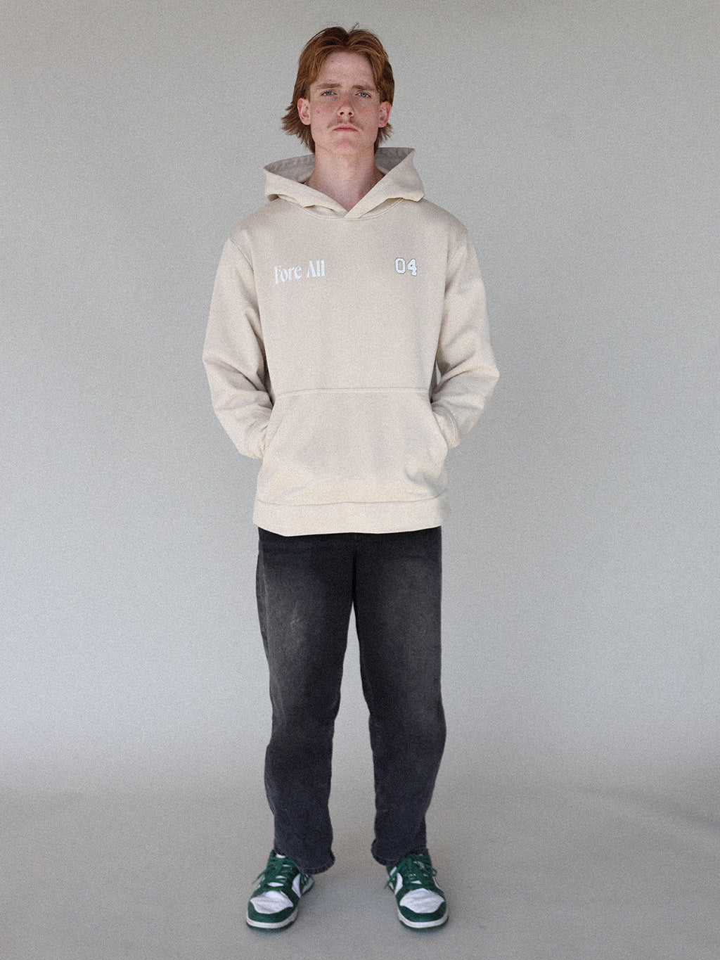 &quot;Close-up of the &#39;Global Hoodie&#39; from the Royal Collection, inspired by autumn hues. This cozy, slightly oversized hoodie features a substantial pocket for golf and personal items and a full-coverage hood. &#39;Fore All&#39; details on the front and back include the classic &#39;Golfing Optional&#39; phrase in five languages. Perfect for combining comfort and global style this season.&quot;