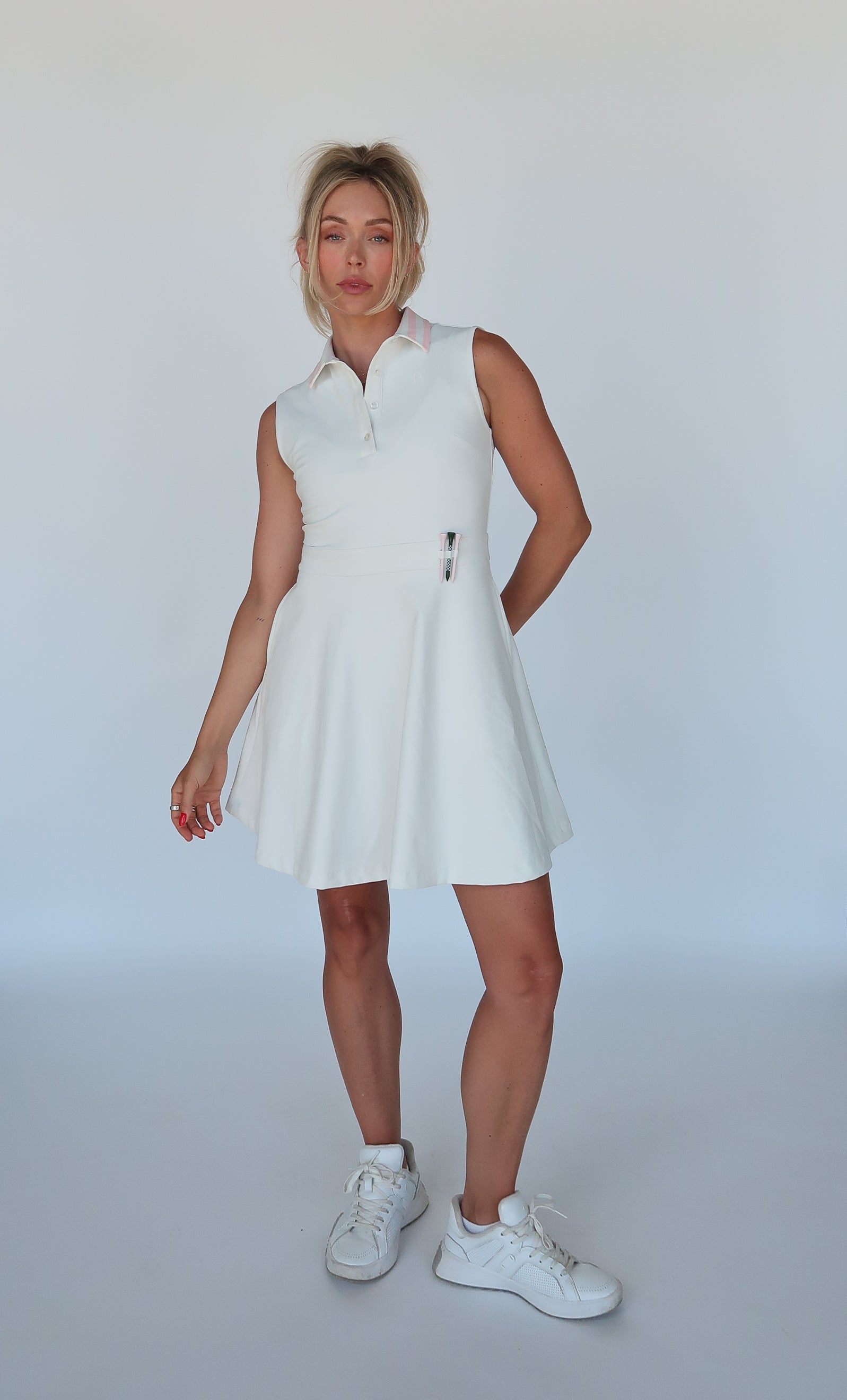 white golf dress with pink collar and tee holders 