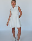 white golf dress with pink collar and tee holders 